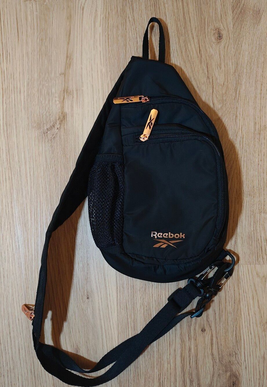 Reebok unisex Black Sling Bag with Copper Accents
